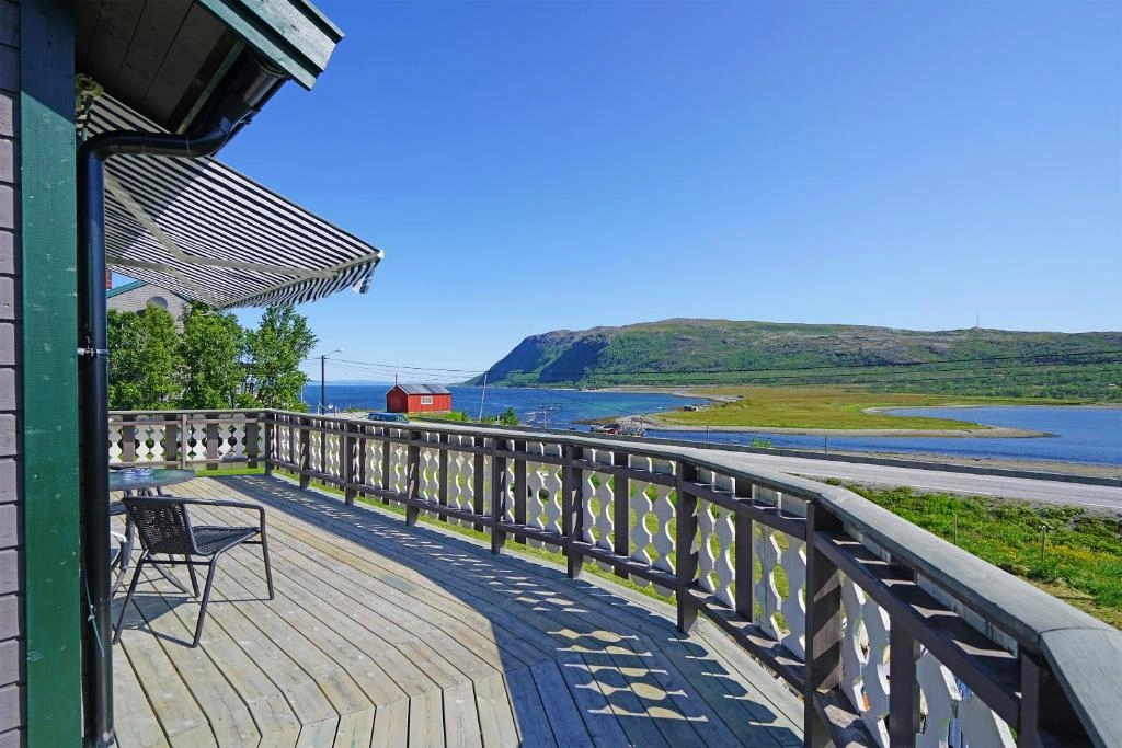 Terrace at Rivdnji Holiday Home with panoramic view over the Porsangerfjord